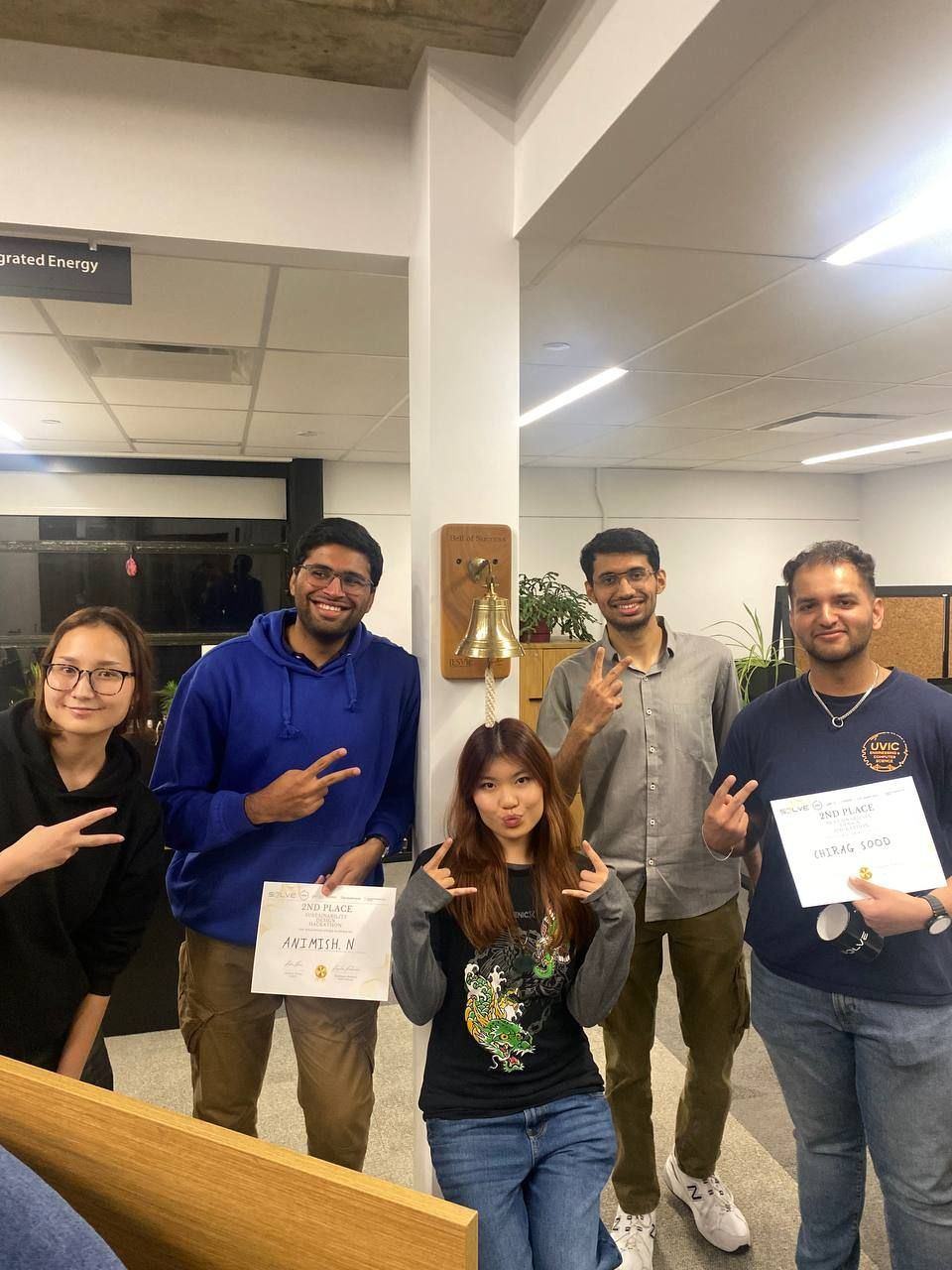 The winning team holding their certificates